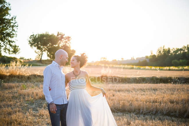 Couple standing face to face in field — Stock Photo