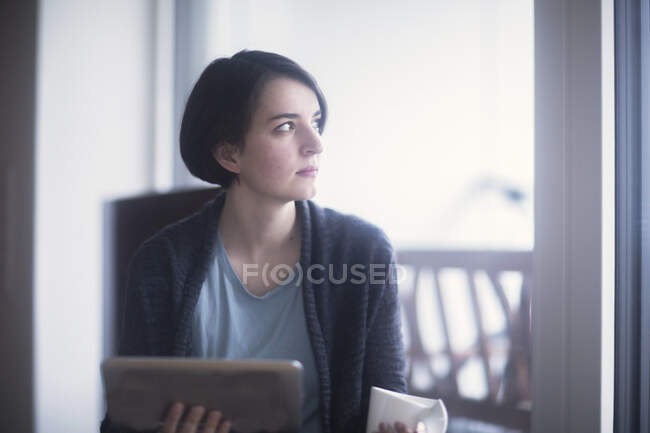 Jeune femme utilisant une tablette numérique — Photo de stock