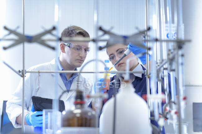 Científicos en laboratorio probando productos químicos en la fábrica de galvanoplastia - foto de stock