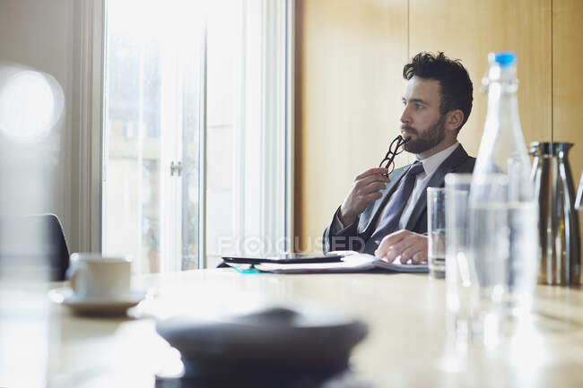 Uomo d'affari contemplando al tavolo della sala riunioni — Foto stock