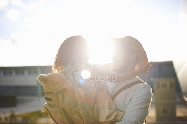 Father carrying daughter in arms — Stock Photo