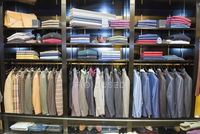 Rows of suit jackets in traditional tailors shop — Stock Photo