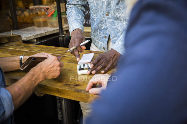 Close up of customer paying vendors — Stock Photo