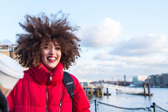 Portrait of smiling young girl against London city at background, England, UK — Stock Photo