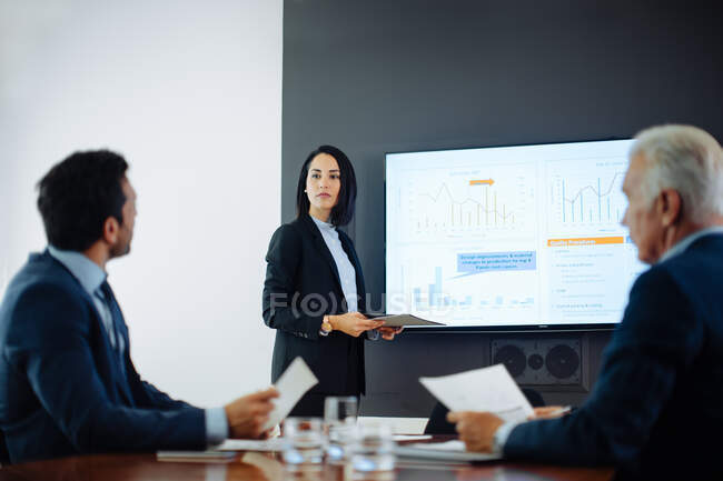 Two businessmen meeting at boardroom presentation — Stock Photo