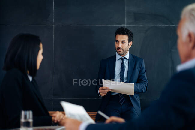 Businessmen and woman meeting in boardroom — Stock Photo