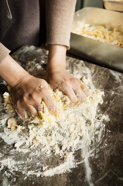 High angle close up of person kneading pasta dough. — Stock Photo