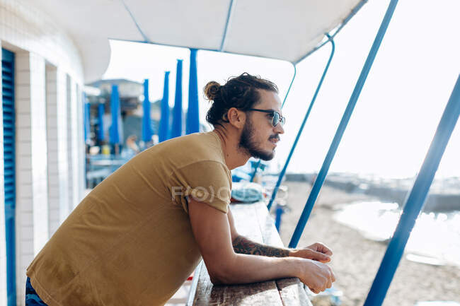 Man relaxing under canopy at sea, Livorno, Italy — Stock Photo