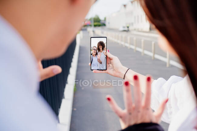 Mixed race group of friends chatting via mobile phone. — Stock Photo