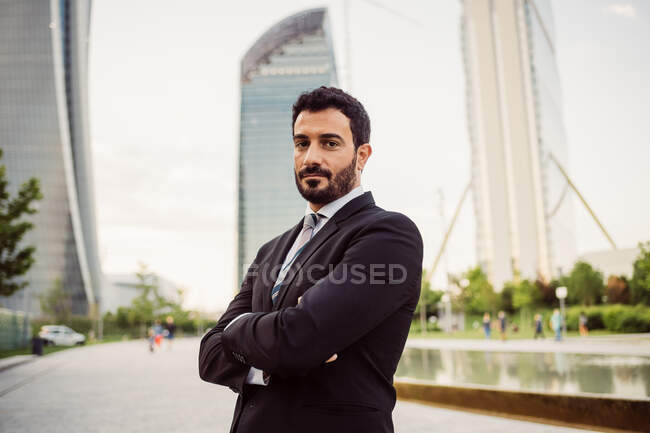 Portrait of bearded businessman wearing dark suit, looking at camera. — Stock Photo