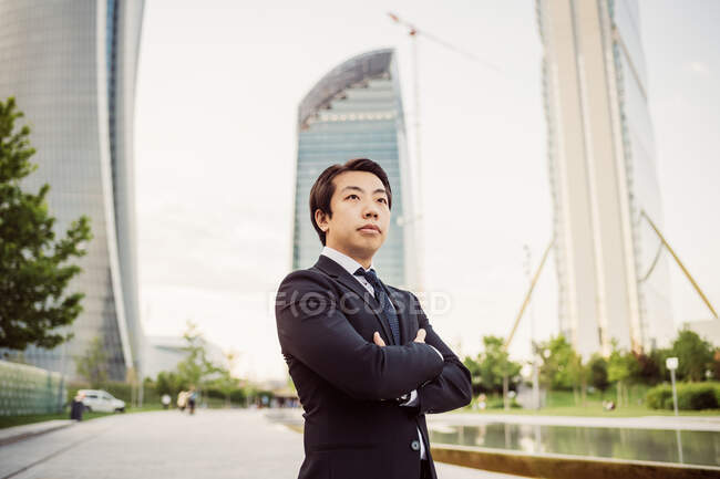 Portrait of Asian businessman wearing dark suit. — Stock Photo