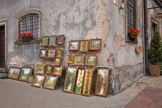 Paintings for sale on city street — Stock Photo
