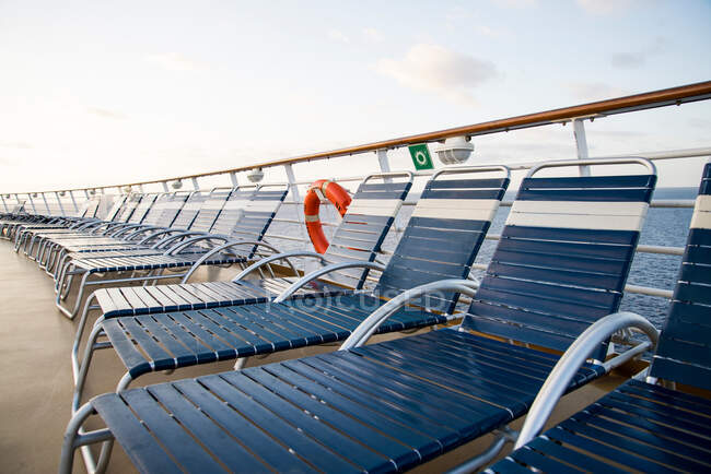 Sunloungers on deck of cruise ship — Stock Photo