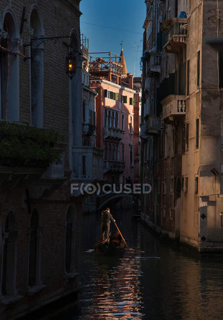 Gondola in a narrow channel of Venice, Italy — Stock Photo