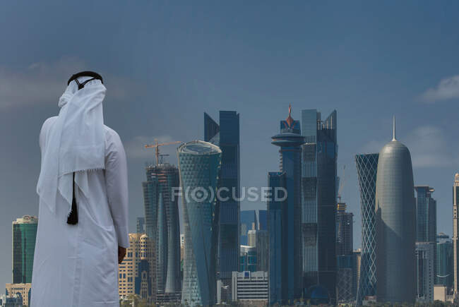 Людина, яка дивиться на футуристичні хмарочоси в центрі міста Доха, Катар. — стокове фото