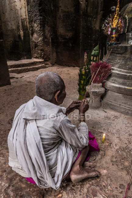 Devotee nun, lighting incense and offering prayers at Preah Khan Temple, Angkor, Cambodia — Stock Photo