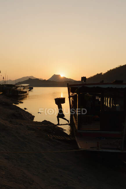 Silhouetted boats on Mekong River at sunset, Luang Prabang, Las — Stock Photo