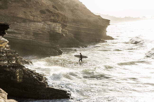 Surfer in sea at sunrise, Taghazout, Morocco — Stock Photo