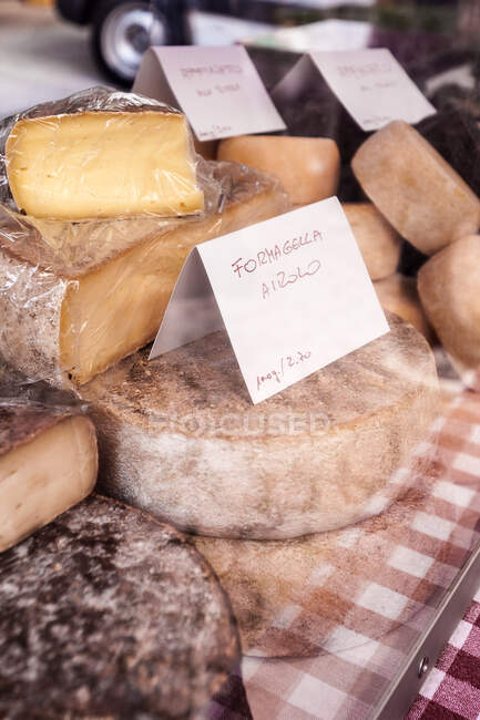 Close up of local cheeses on market stall, Bellinzona, Ticino, Switzerland — Stock Photo