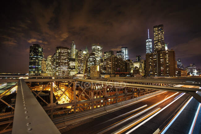 Vista del Distrito Financiero desde Brooklyn Bridge por la noche, Nueva York - foto de stock