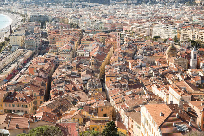 High angle view of rooftops and coast, Nice, France — Stock Photo