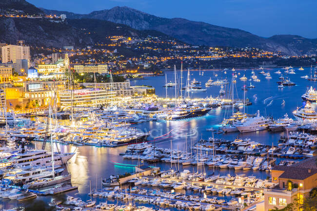 Elevated view of superyachts at Monaco yacht show at dusk — Stock Photo
