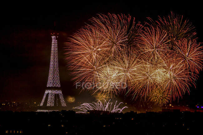 Eiffel Tower and orange fireworks at night, Paris, France — Stock Photo