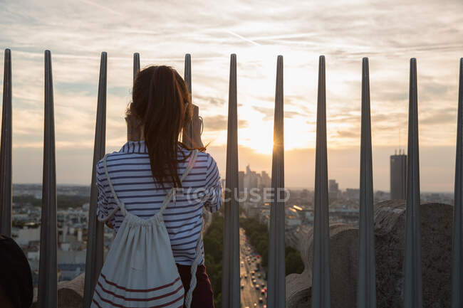 Woman photographing Paris skyline, France — Stock Photo