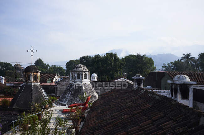 Distant view of mountains beyond rooftops from garden terrace, A — Stock Photo