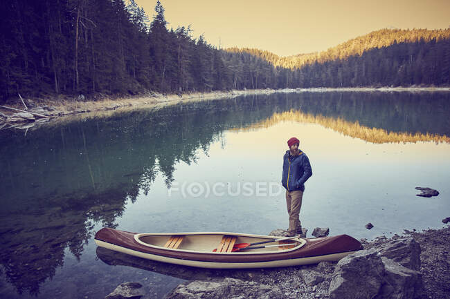 Uomo accanto alla canoa, lago Eibsee alla base di Zugspitze, Garmisch-Par — Foto stock