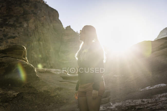 Woman standing on mountain, looking at view, Zion National Park — Stock Photo