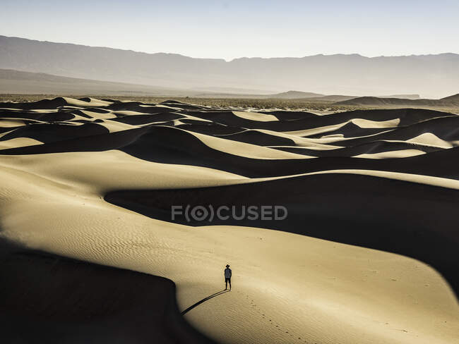 Одинокий путешественник по плоским дюнам Мескита, Национальный парк Долины Смерти — стоковое фото