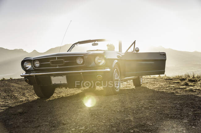 Man sitting in vintage convertible at sunset, Franchook, South A — Stock Photo