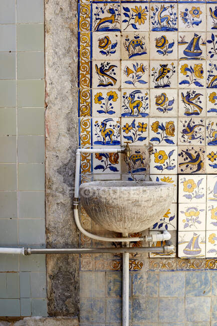 Stone basin, tiled wall background, Lisbon, Portugal — Stock Photo