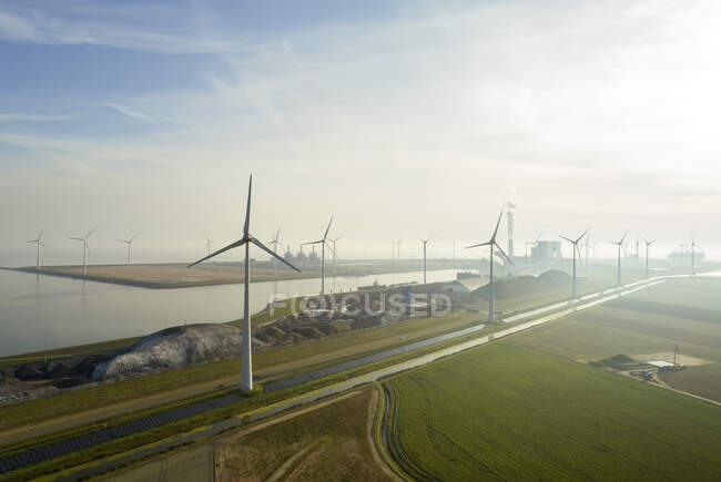 Wind turbines in the Eemshaven area; a harbour with several coal — Stock Photo