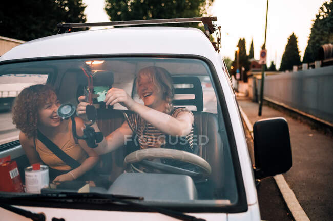 Young female couple laughing in van — Stock Photo