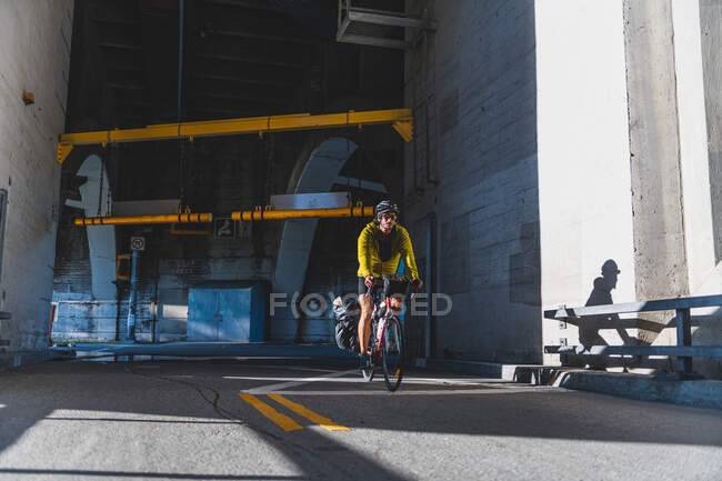 Cyclist emerging from tunnel, Ontario, Canada — Stock Photo