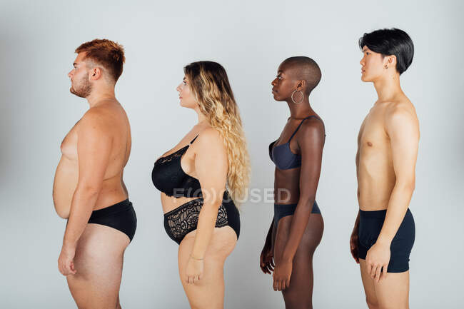 Young people wearing underwear, standing in a row — Stock Photo