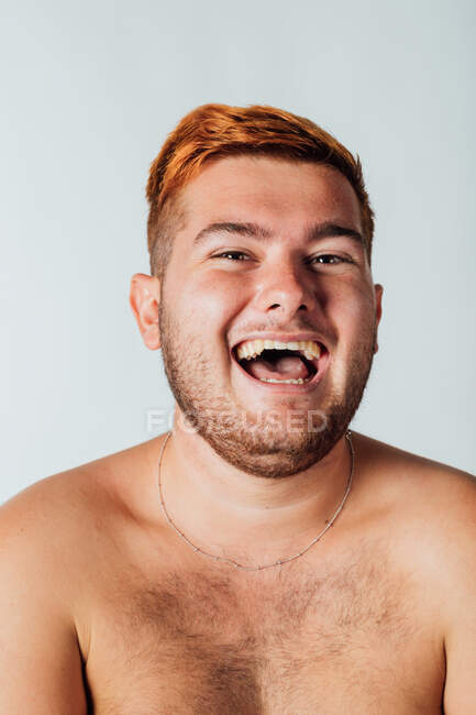 Portrait of a young man with bare chest, laughing — Stock Photo