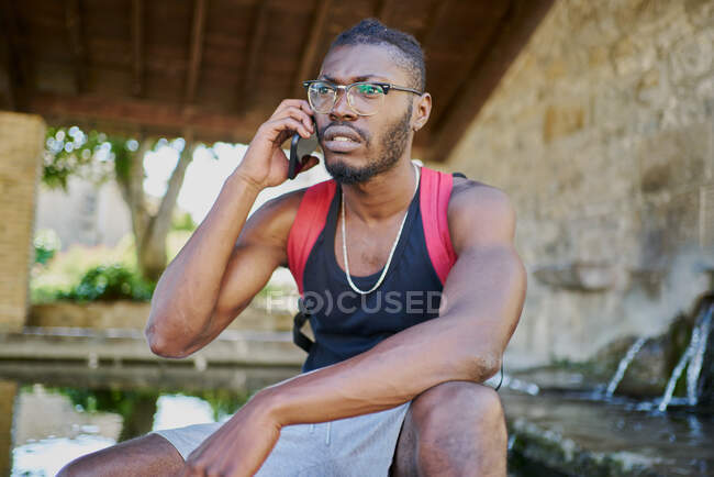 Young man on phone call outdoors — Stock Photo