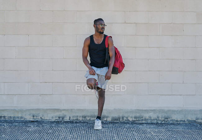 Portrait of young man standing by a wall — Stock Photo