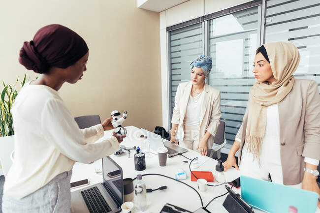 Female colleagues discussing robot — Stock Photo