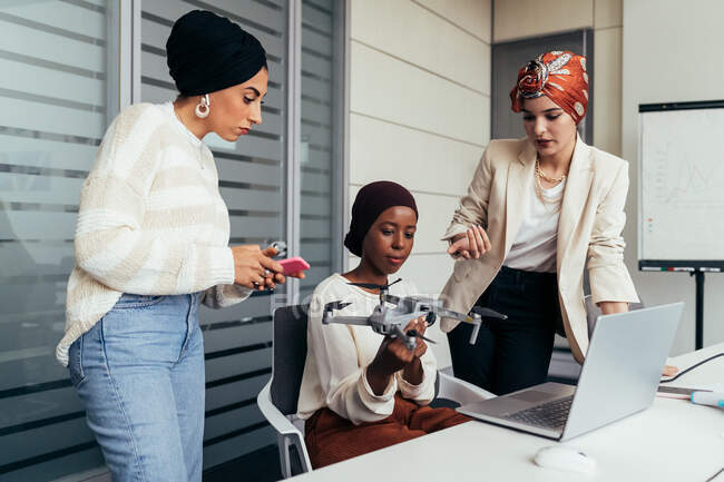 Female colleagues in office discussing drone — Stock Photo