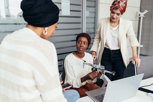 Female colleagues in office discussing drone — Stock Photo