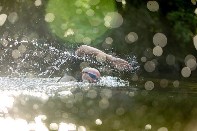 Uomo che nuota nel fiume — Foto stock