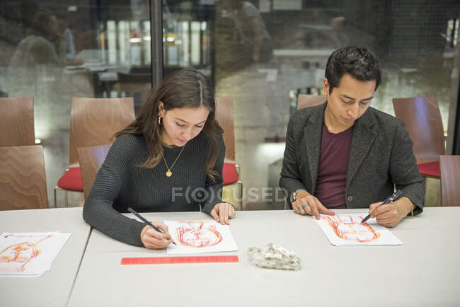 Estudiantes dibujando en la mesa - foto de stock