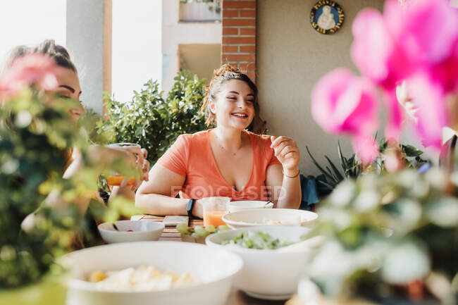 Young woman at meal on balcony — Stock Photo