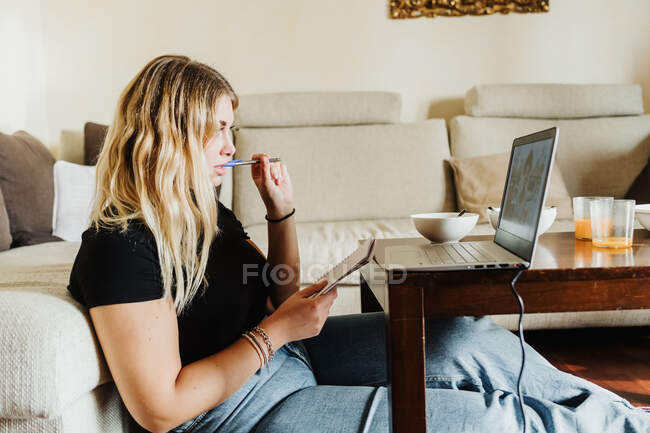 Mujer joven aprendiendo en línea - foto de stock
