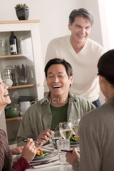Mature friends enjoying meal together — Stock Photo