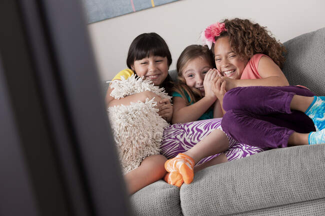 Три девушки смотрят телевизор — стоковое фото